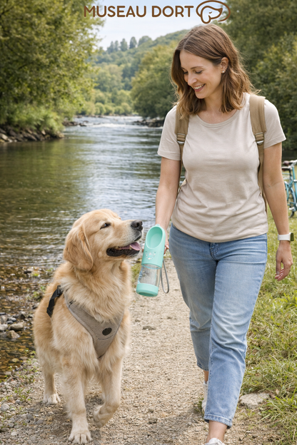 Femme promenant son chien au bord d’une rivière avec une bouteille d’eau portable pour chien lors d’une balade, Museau Dort